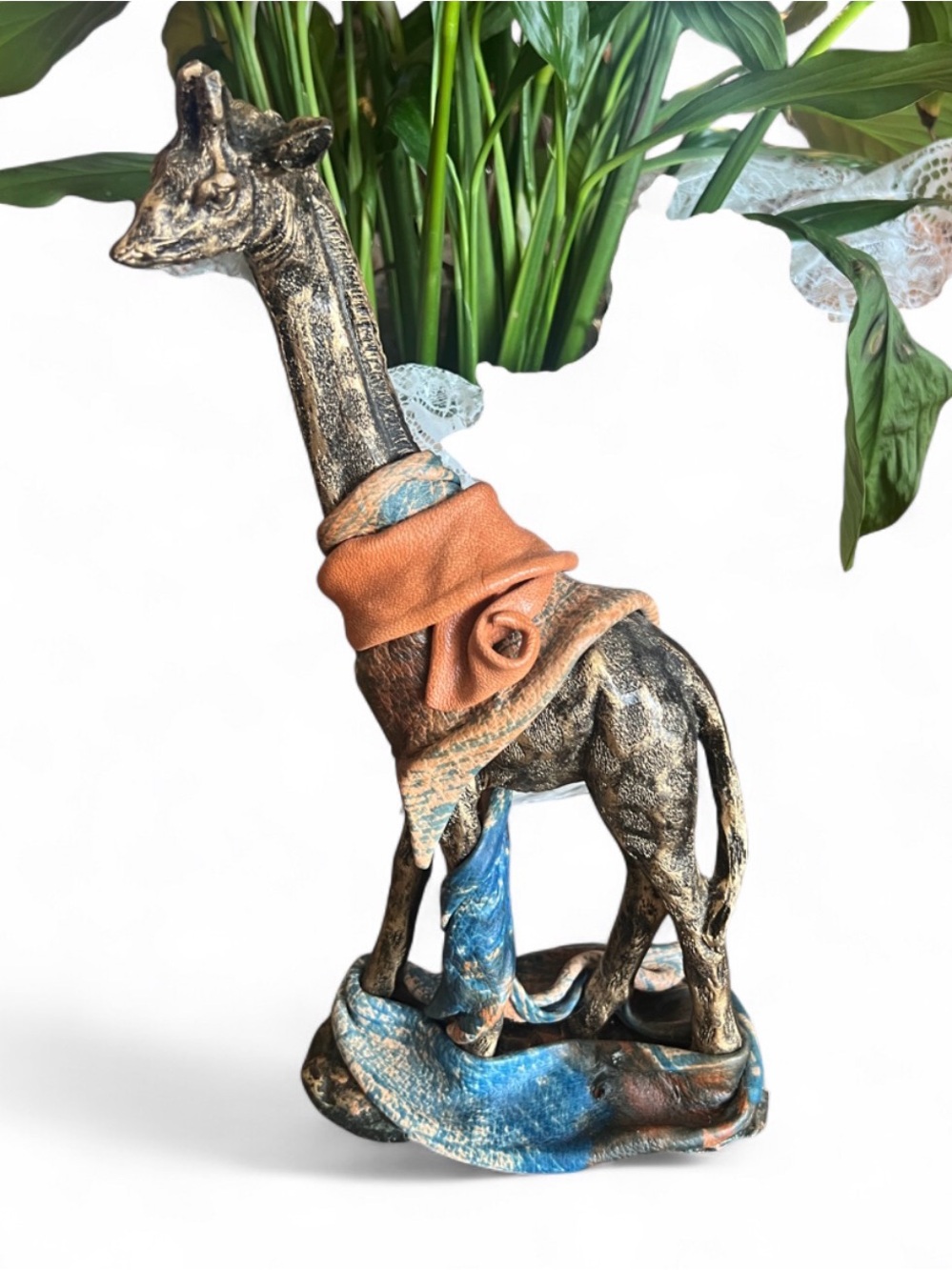 Metal look resin giraffe with leather wraps